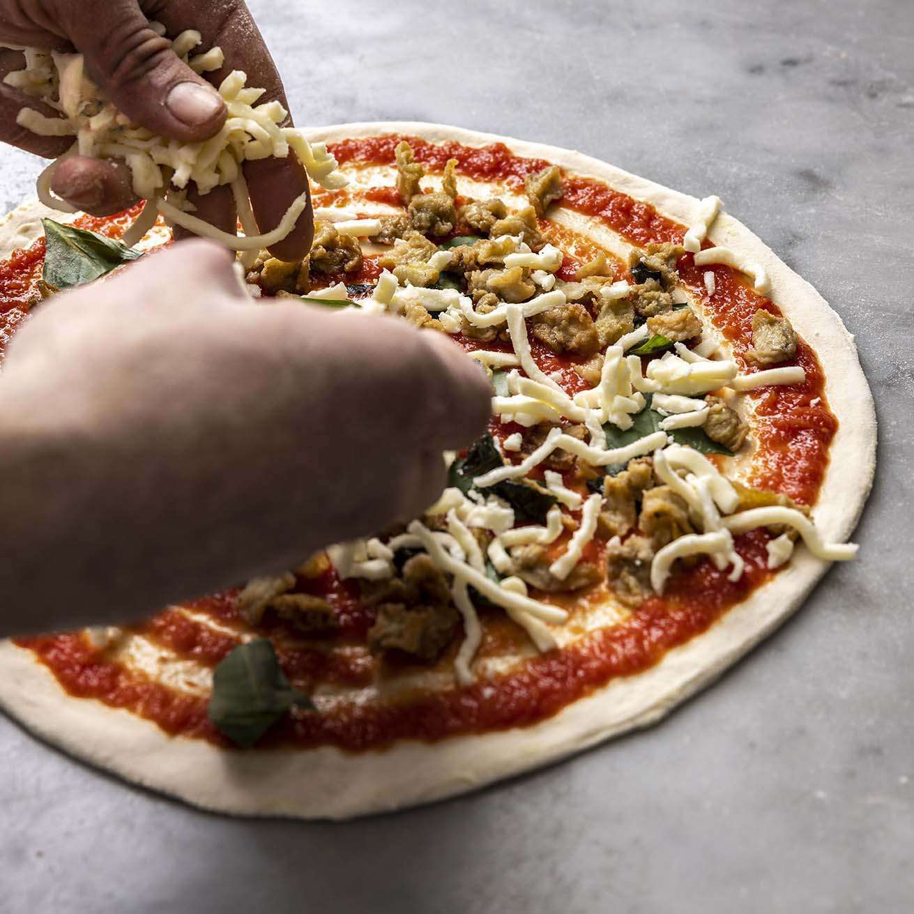 fresh, seasonal toppings on pizza sprinkling of fresh, seasonal toppings on pizza
