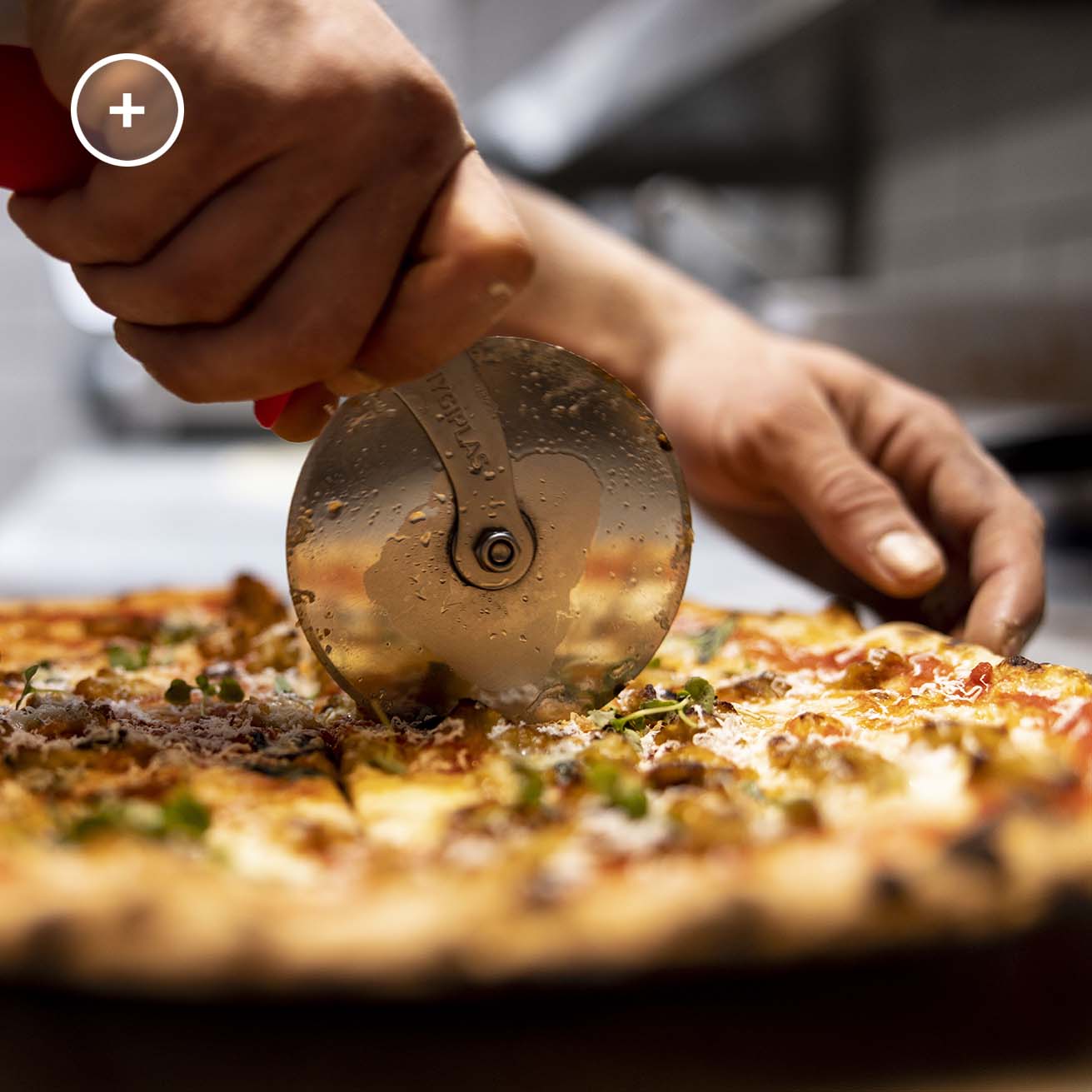 slicing of a well cooked, crunchy pizza